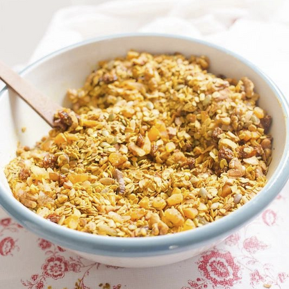 bowl of sweet debbie's sugar-free, gluten-free and organic golden glow crunch granola with golden berries, sprouted walnuts, sprouted almonds and hojicha green tea 